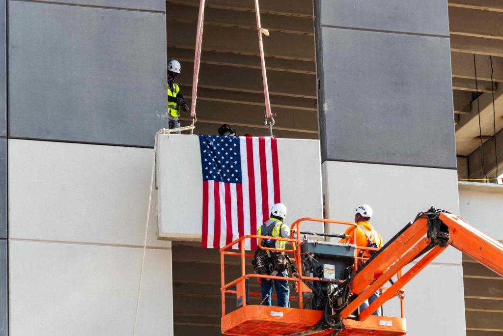 Aligned Federal Data Center Solutions with workers putting US flag on building